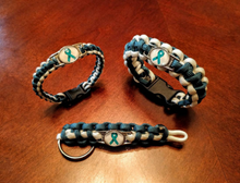 Load image into Gallery viewer, Teal Ribbon Sexual Assault Anxiety MST OCD Ovarian cancer Panic disorder PTSD Tourettes Awareness Paracord Bracelet, Keychain or Necklace