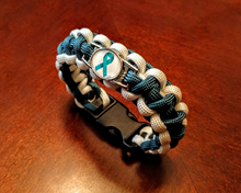 Load image into Gallery viewer, Teal Ribbon Sexual Assault Anxiety MST OCD Ovarian cancer Panic disorder PTSD Tourettes Awareness Paracord Bracelet, Keychain or Necklace